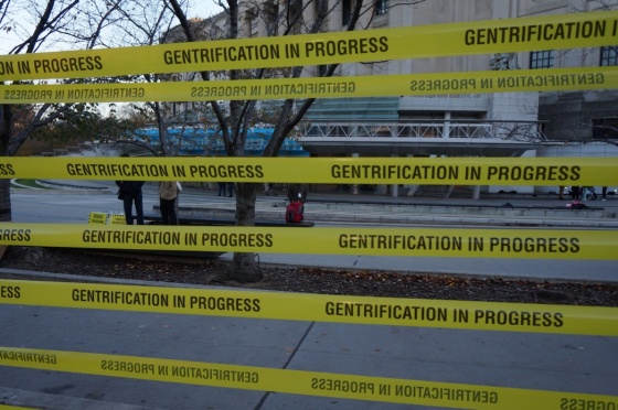 “Gentrification in progress” tape at the “Double Crossing Brooklyn” protest outside the Brooklyn Museum (Jillian Steinhauer for Hyperallergic). http://goo.gl/G7U9P9